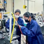 Akane Wakai, Ph.D. ’24, and Jennifer Bustillos, Ph.D. ’24, prepare a sample at the Cornell High Energy Synchrotron Source.