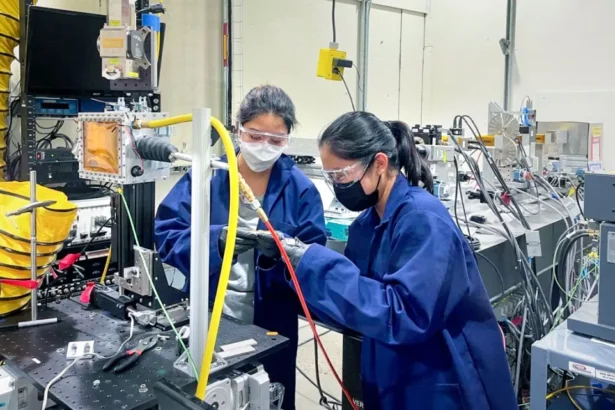 Akane Wakai, Ph.D. ’24, and Jennifer Bustillos, Ph.D. ’24, prepare a sample at the Cornell High Energy Synchrotron Source.