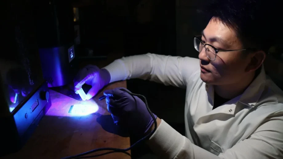 Purdue University postdoctoral student Yujie Shan examines 3D printed items in Huachao Mao’s Additive and Intelligent Manufacturing Lab. Mao and his team are improving upon traditional fabrication methods and 3D printing to construct multilevel microfluidic devices as small as 10 microns deep and 100 microns wide. (Purdue University photo/John O’Malley)