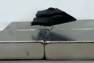A sample of a superconductor 3D printed from a single seed — this one shaped like a paper airplane — is shown levitating over a magnet. Credit: Dingchang Zhang . Source: Fermilab.
