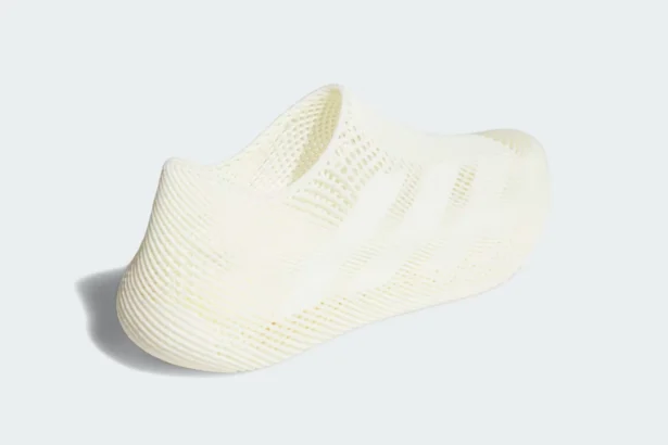 Adidas Climacool Slip‑On — full side view of the cream‑colored, one‑piece 3D‑printed sneaker on a light‑grey background.