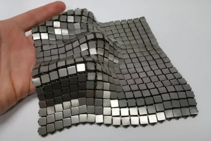 NASA space fabric prototype draped over a gloved hand
