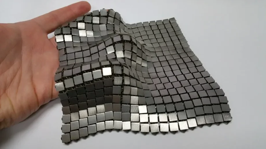NASA space fabric prototype draped over a gloved hand