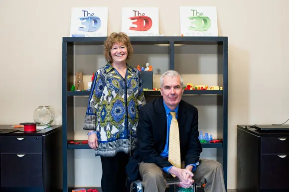 Debra Wilcox and Kenton Kuhn pose amid 3‑D prints at The 3‑D Printing Store, Denver.