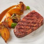 Plated 3D‑printed, plant‑based steak with roasted veggies