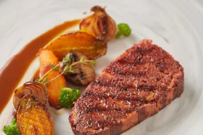 Plated 3D‑printed, plant‑based steak with roasted veggies