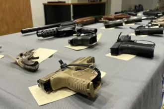 Handguns tagged and displayed after NYPD / ATF ghost‑gun seizure, March 2023