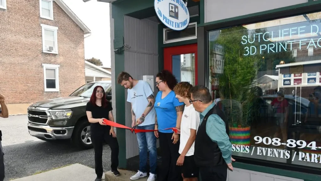 Ryan Sutcliffe cuts ribbon outside Sutcliffe Designs 3‑D Print Factory, Nazareth, PA.
