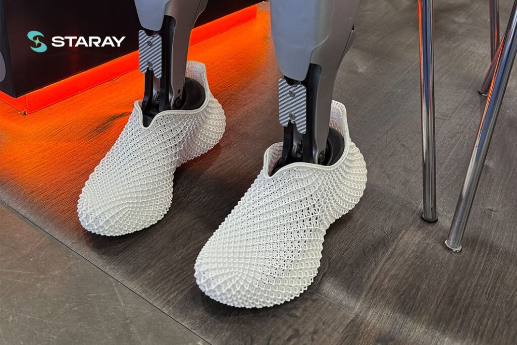 Wide shot of visitors engaging with the STARAY CES 2026 exhibit showcasing 3D-printed shoes