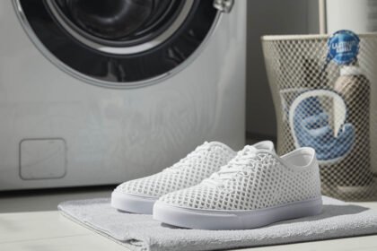 3D printed TPU lattice shoes beside a washing machine with a laundry bag for safe cleaning