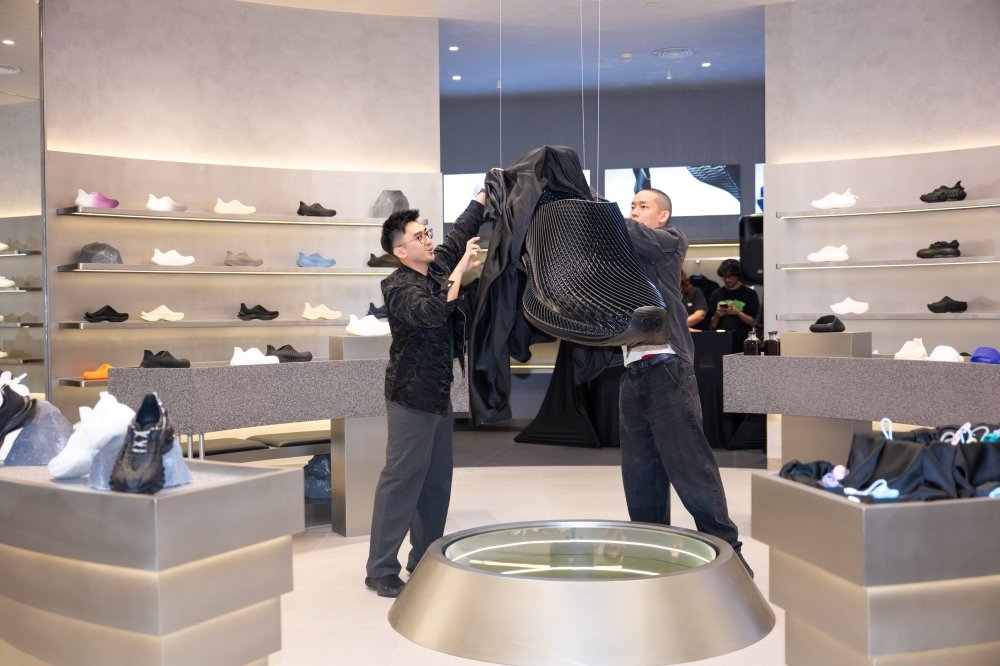 2AM team unveiling a large 3D printed shoe display at its Malaysia store